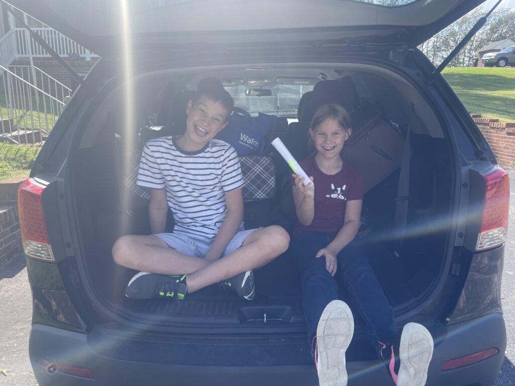 kids smiling in back of car. Are You Setting Your Child up to be Poor? Skills They Need Now